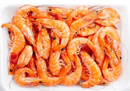 Boiled prawns on white plate, top view, isolated on white backgroundの写真素材