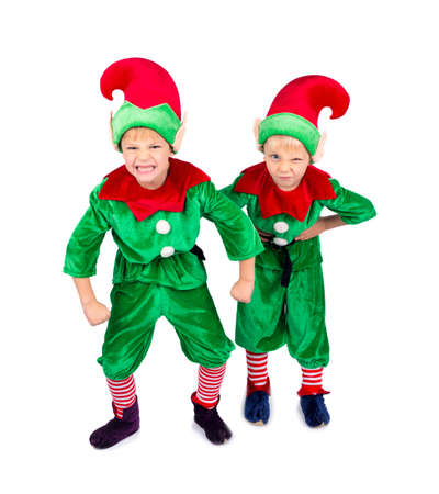Little boys dressed like small elf, with christmas hats, isolated on white backgroundの写真素材