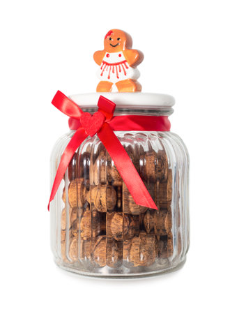Christmas gift in a glass jar: walnuts isolated on white backgroundの写真素材