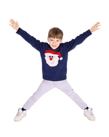 Portrait of little boy posing for studio shot in Christmas timeの写真素材