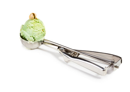 Scoop home made pistachio ice cream. Cold summer dessert isolated on white backgroundの写真素材