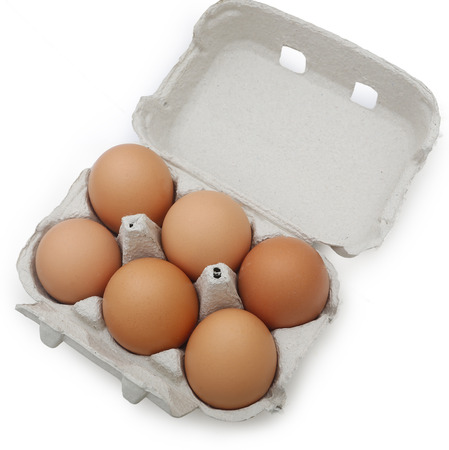 Eggs in the package on wooden tableの写真素材