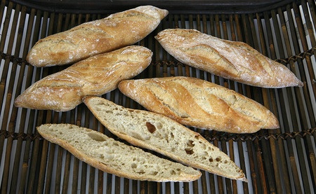 bread baked in a traditional oven and sliced breadの写真素材