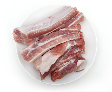 pieces of pork chop on a white plateの写真素材