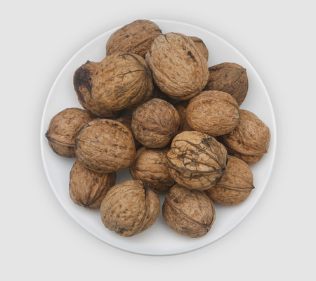 A Dish of walnuts on white plateの写真素材