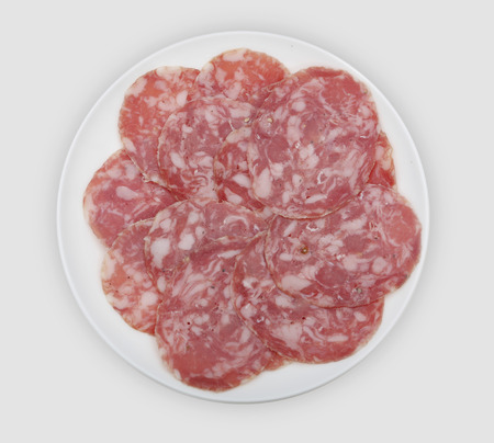 slices of sausage on white plateの写真素材