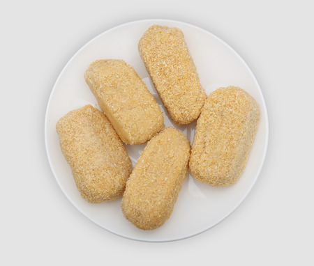croquetas prepared to fry on a white plateの写真素材