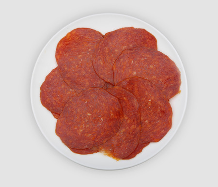 slices of sausage on white plateの写真素材