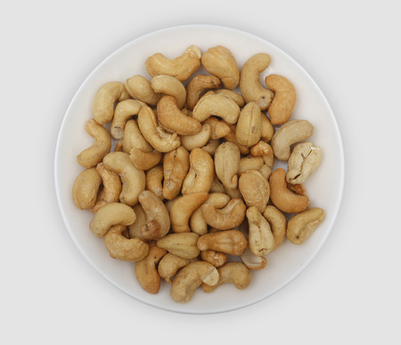 roasted cashew nuts on a white plate. Nut rich in vitamin Bの写真素材