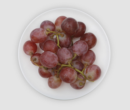 purple grapes on a white plate. Fresh fruit rich in vitamin Bの写真素材