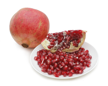 Granada beans on a white plate. Fresh fruit rich in vitamin B and Cの写真素材
