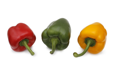 a yellow pepper, green pepper and red pepper on white backgroundの写真素材
