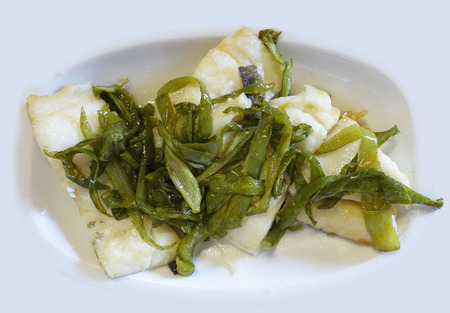 A white dish with cod with peppersの写真素材