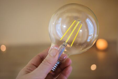 hand holding a beautiful light bulb. Idea concept with innovation and inspiration.の写真素材