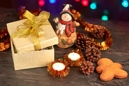 Gingerbread cookies in a gift box, Christmas toys around, tangerines, cones, candles. Festive...