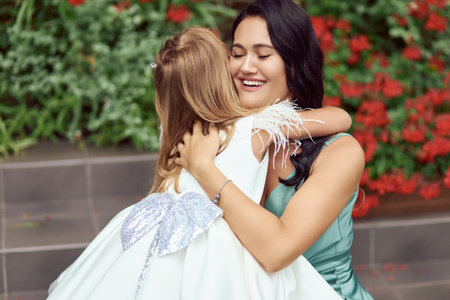Mother and daughter hug. A happy mother loves and hugs her five-year-old daughter dearly.の写真素材