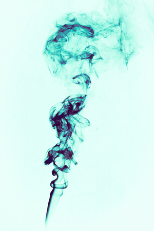 Trail of the smoke on a black paperの写真素材