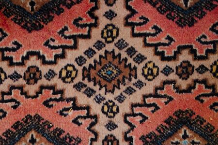 close-up photograph of the texture of a carpet with geometric embroidery