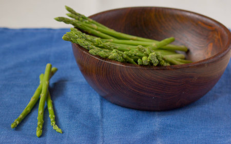 Fresh green asparagus on a plateの写真素材