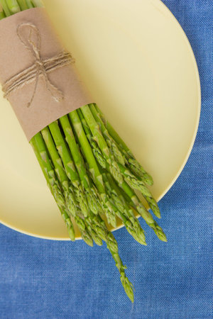 Fresh green asparagus on a plateの写真素材