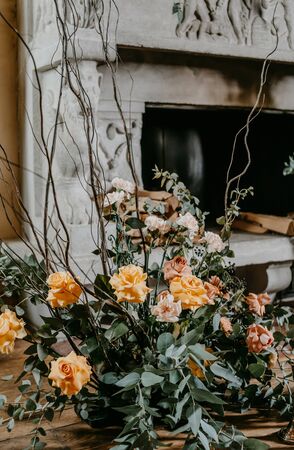 Decorated with roses and other flowers fireplace without fireの写真素材