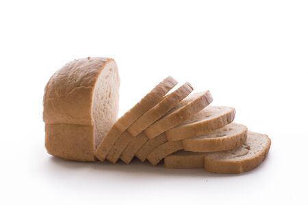 Fresh baked homemade bread and sliced bread isolated on a whiteの写真素材