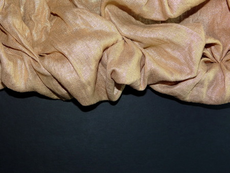 gold fabric on a black backgroundの写真素材