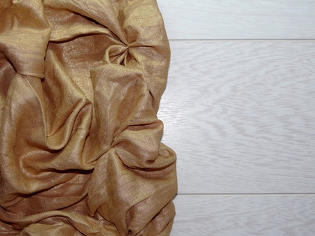 gold fabric on the woodの写真素材
