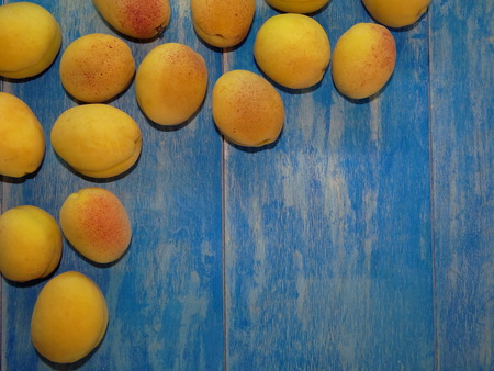 apricots on blue wooden boardsの写真素材