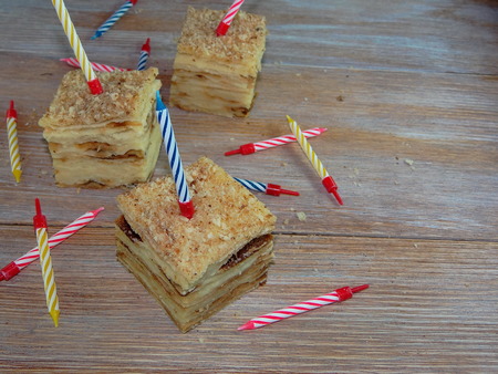 piece of birthday cake with candlesの写真素材