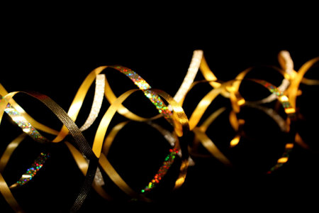 beautiful festive background, golden serpentine on a black backgroundの写真素材