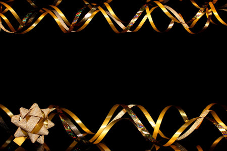 beautiful festive background, golden serpentine on a black backgroundの写真素材