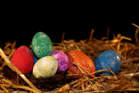 beautiful colorful Easter eggs lie on the strawの写真素材