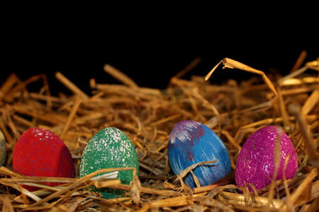 beautiful colorful Easter eggs lie on the strawの写真素材