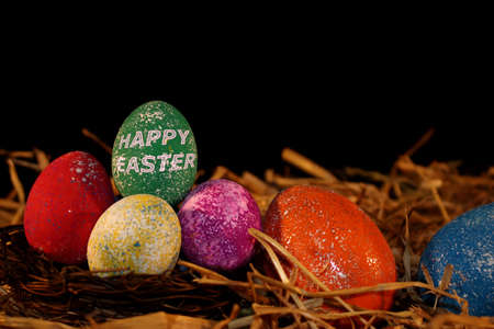 beautiful colorful Easter eggs lie on the strawの写真素材