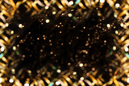 beautiful shiny gold background on a dark backgroundの写真素材