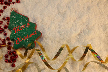 beautiful green Christmas tree lies on the white snowの写真素材