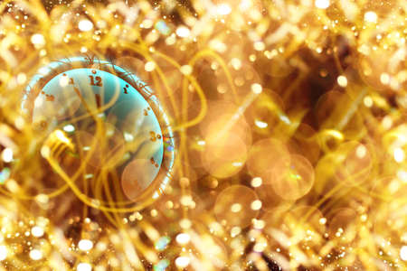 beautiful Christmas clock on a shiny gold backgroundの写真素材
