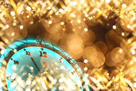 beautiful Christmas clock on a shiny gold backgroundの写真素材