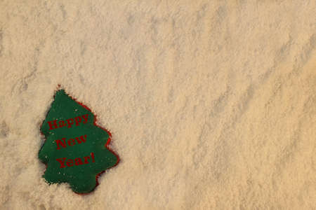 beautiful green Christmas tree lies on the white snowの写真素材