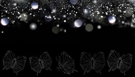 beautiful pattern of butterflies made of sequins on a black backgroundの写真素材
