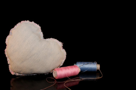 beautiful heart made of denim fabric on a black backgroundの写真素材