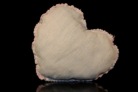 beautiful heart made of denim fabric on a black backgroundの写真素材