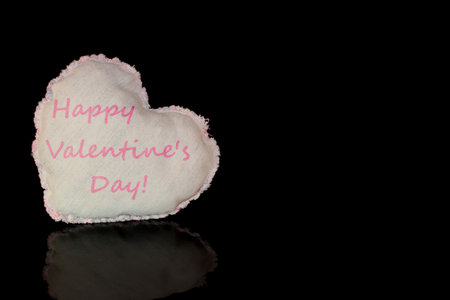 beautiful heart made of denim fabric on a black background with the inscription "Happy Valentine's Day"の写真素材