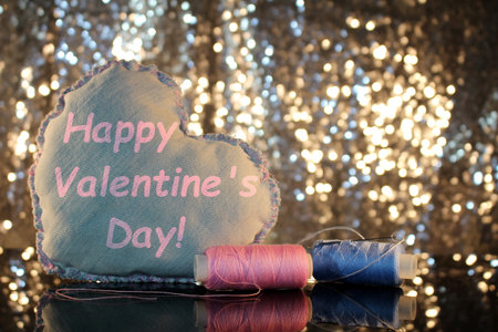 beautiful heart made of denim fabric on a shiny backgroundの写真素材