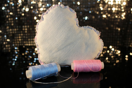 beautiful heart made of denim fabric on a shiny backgroundの写真素材