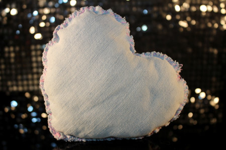 beautiful heart made of denim fabric on a shiny backgroundの写真素材
