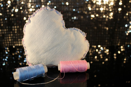 beautiful heart made of denim fabric on a shiny backgroundの写真素材