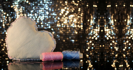 beautiful heart made of denim fabric on a shiny backgroundの写真素材