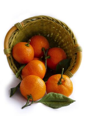 basket with tangerines on a white backgroundの写真素材